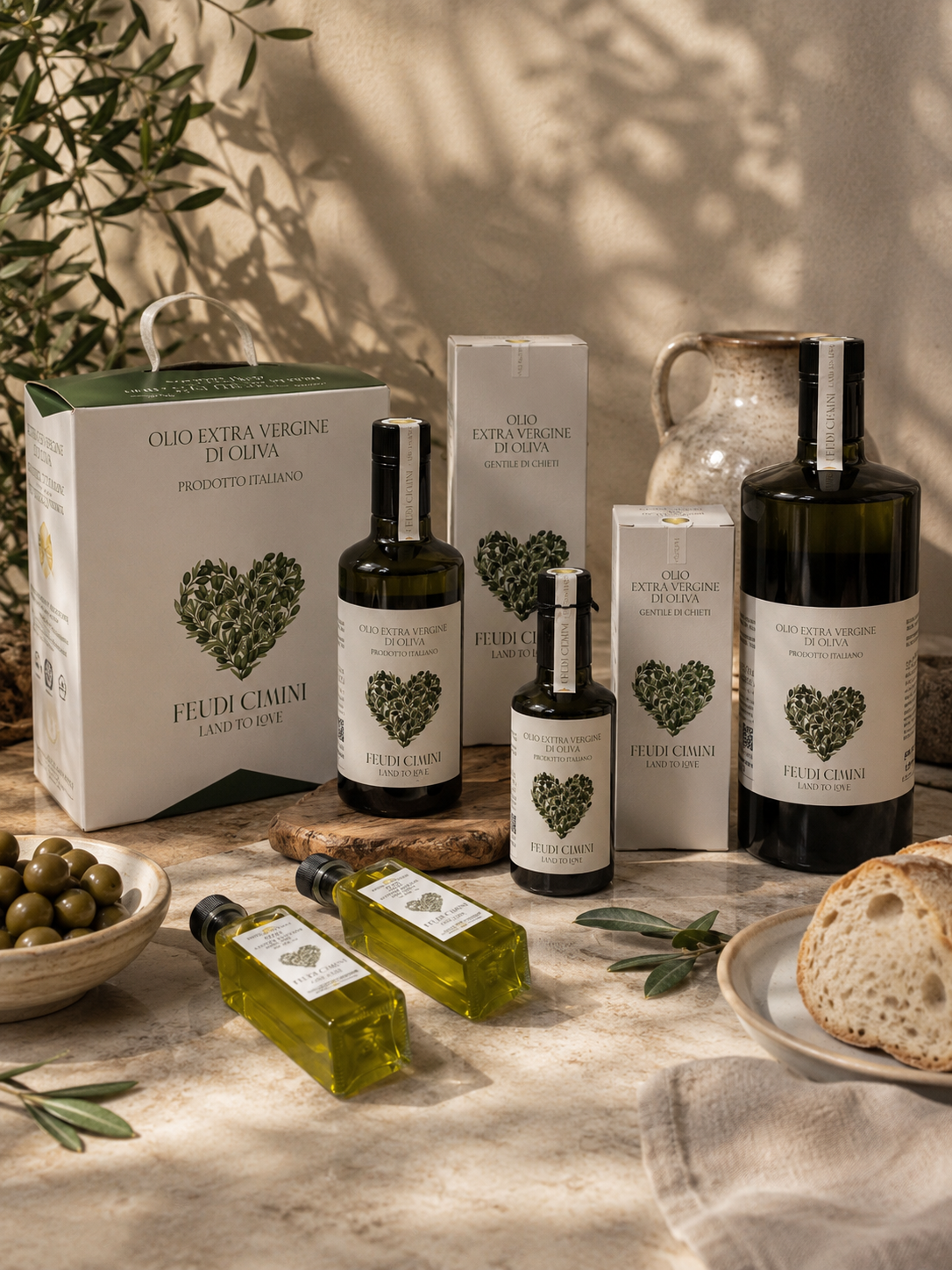 Dark glass olive oil bottle on a rustic wooden surface with loose olives